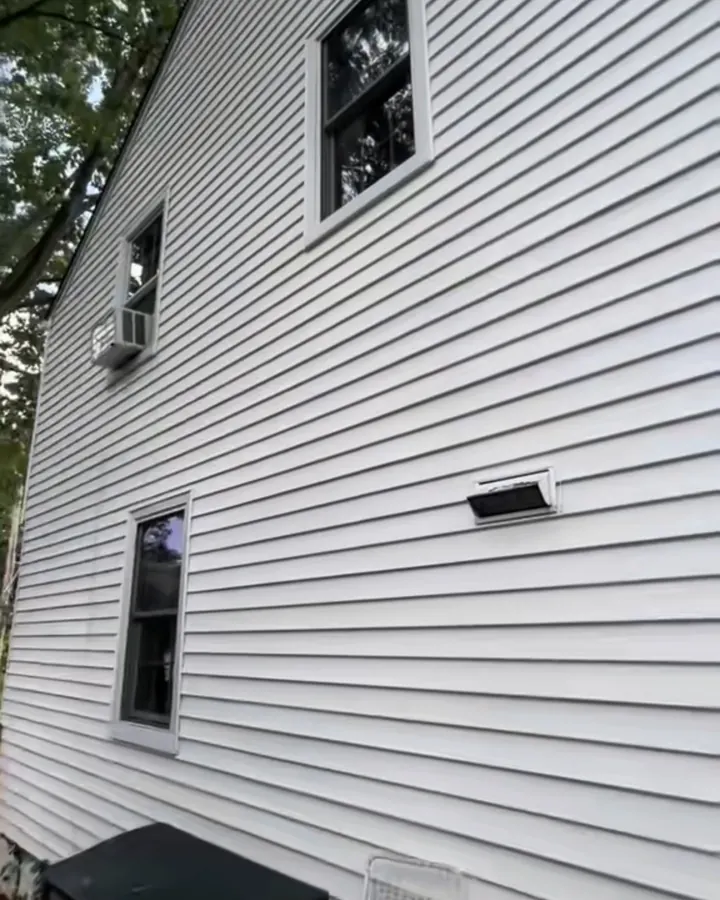 The same siding bright white after soft washing